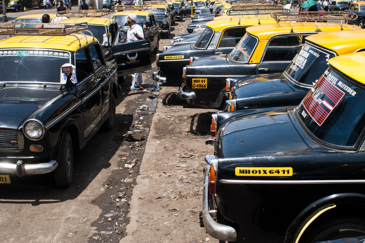 Black and yellow taxis on a Bombay street.